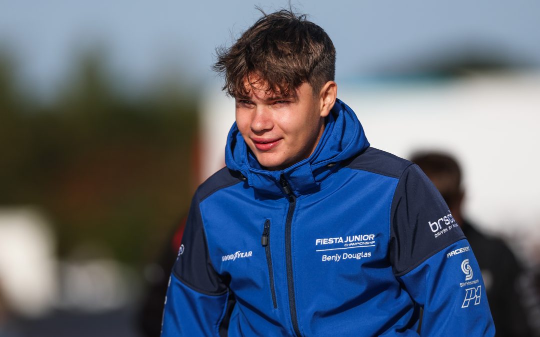 A Ford Fiesta Junior Championship race car on track at Donington Park during Round 6, pushing hard through a corner in a competitive race.